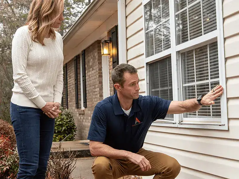 A pest technician checks a home to provide pest control Asheville.