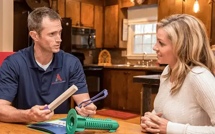 Male pest professional explains termite test to female homeowner. termite treatment, termite inspection, termite exterminator, termite pest control Blowing Rock NC.