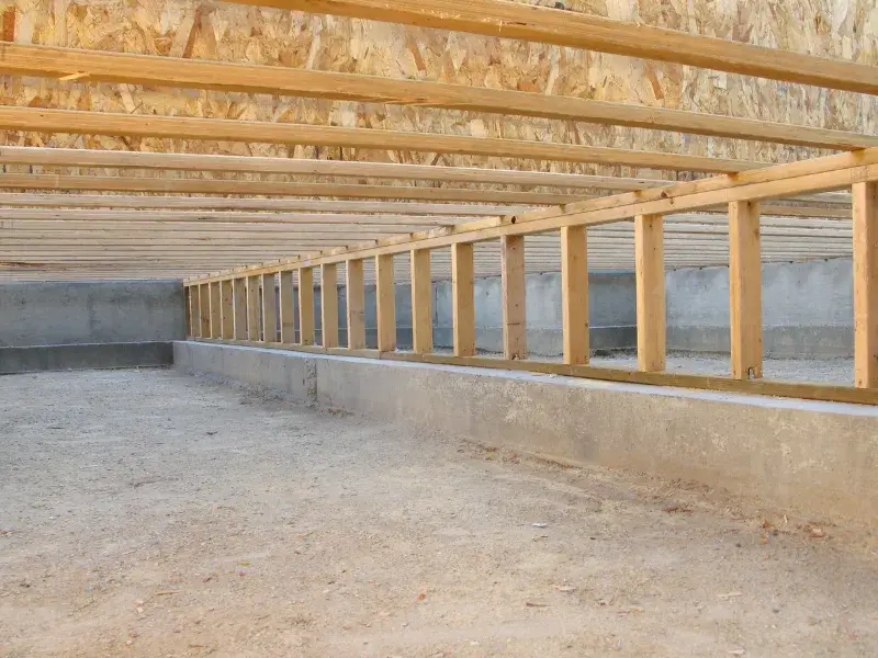 Clean crawlspace with floor joists and pony wall. Page title: Crawlspace encapsulation service in Boone, NC.