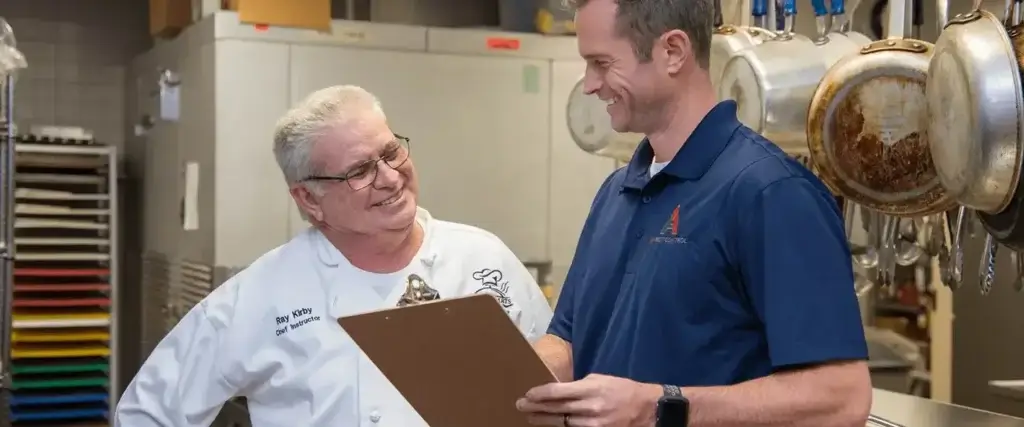 Pest professional and business owner review results of an inspection, highlighting the need for commercial pest control in Hendersonville, NC.