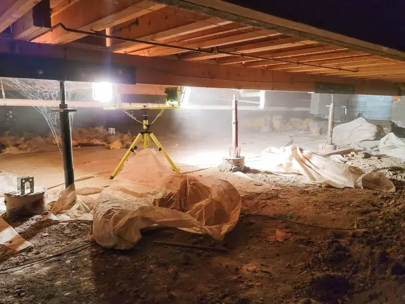 The clean up of a vapor barrier, highlighting the need for crawl space encapsulation in West Jefferson, NC.